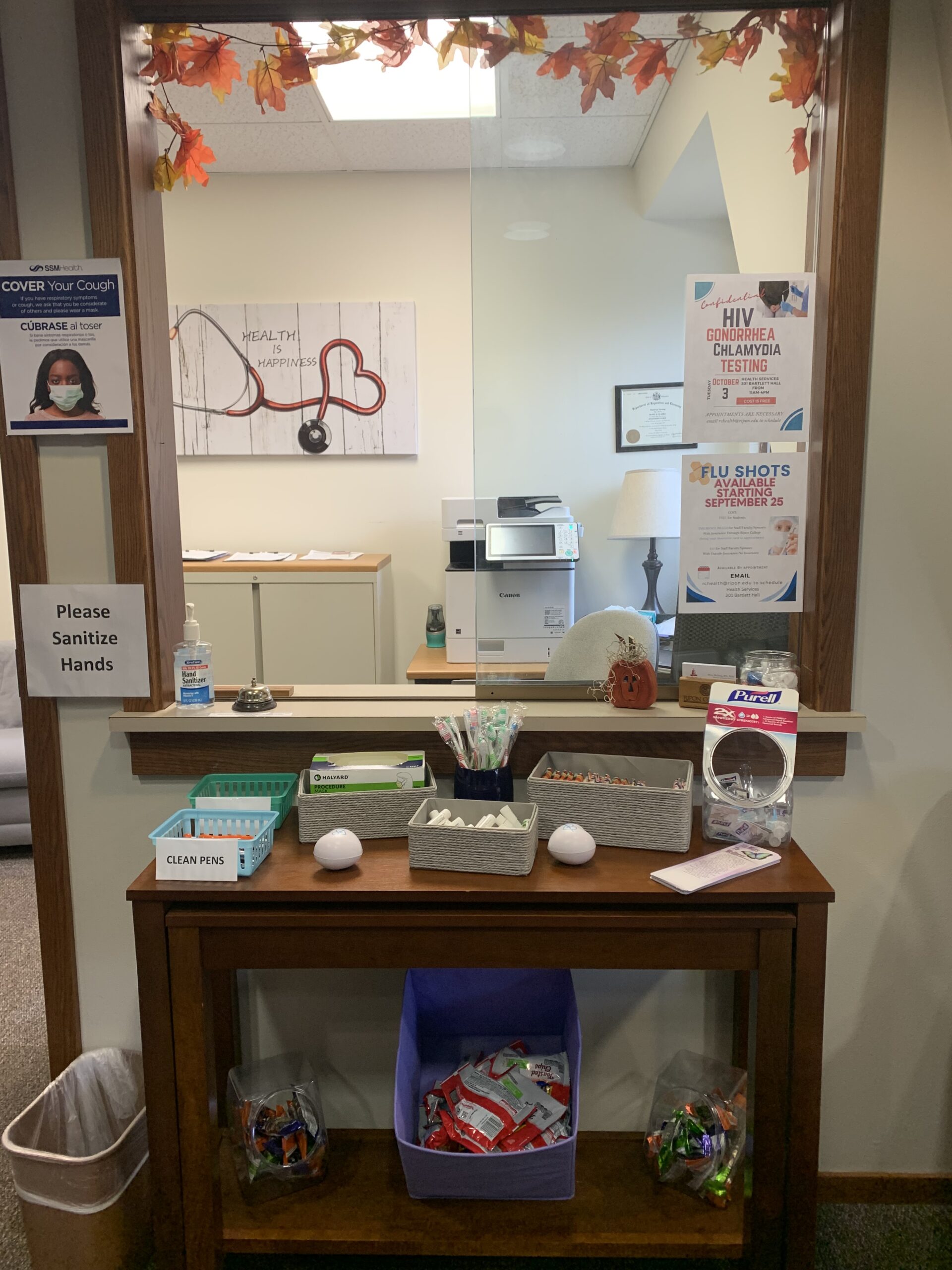 A table in Health Services holds toothbrushes, hand sanitizer, masks, snacks, and more! Photo courtesy of Gwen Frei.