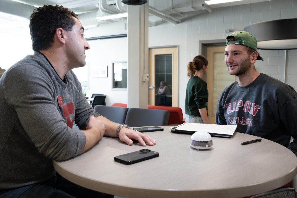 Junior, Miki Canak, interviews Alumni, Andrew Peck. Photo Courtesy of Ric Damm.